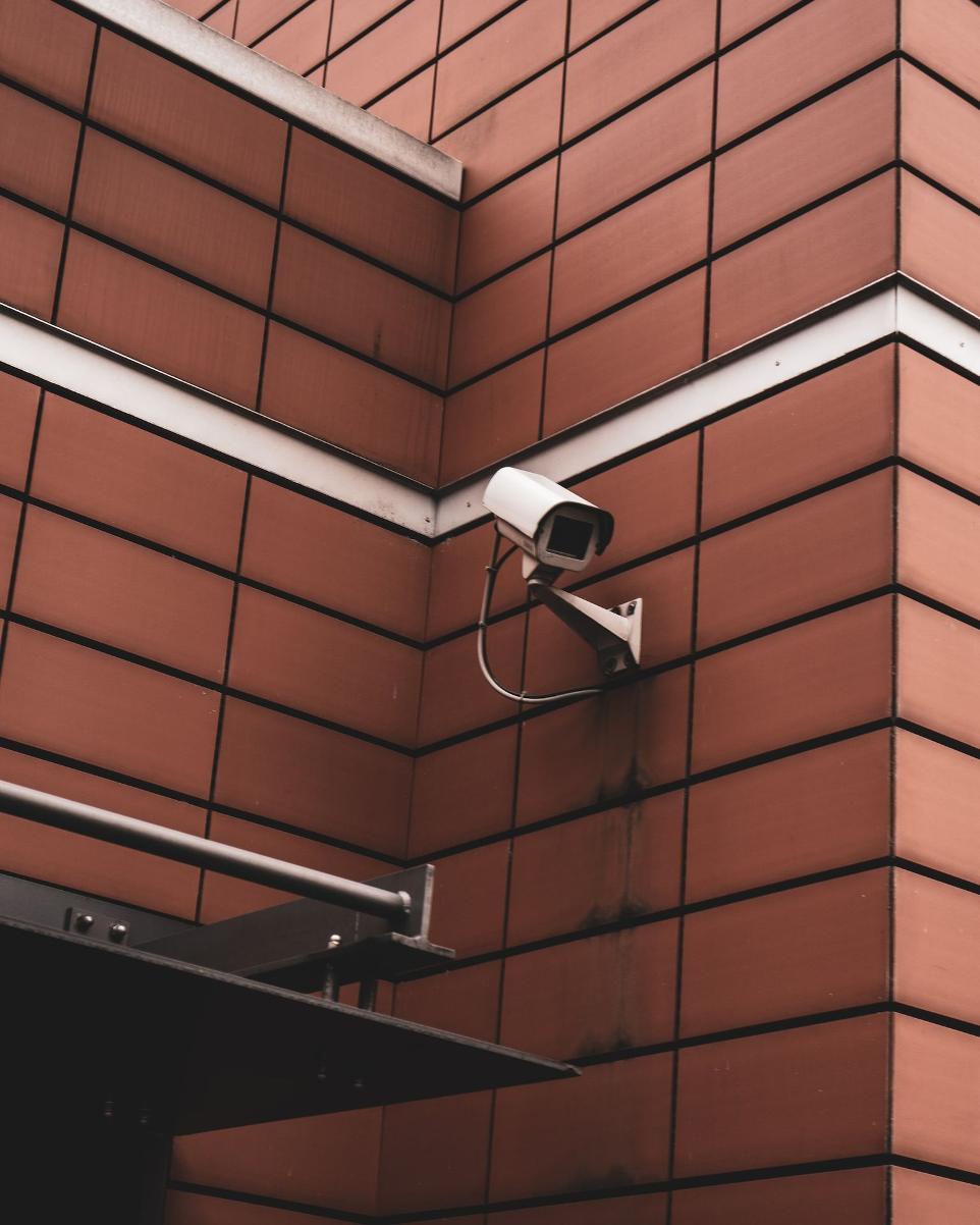 white security camera beside wall